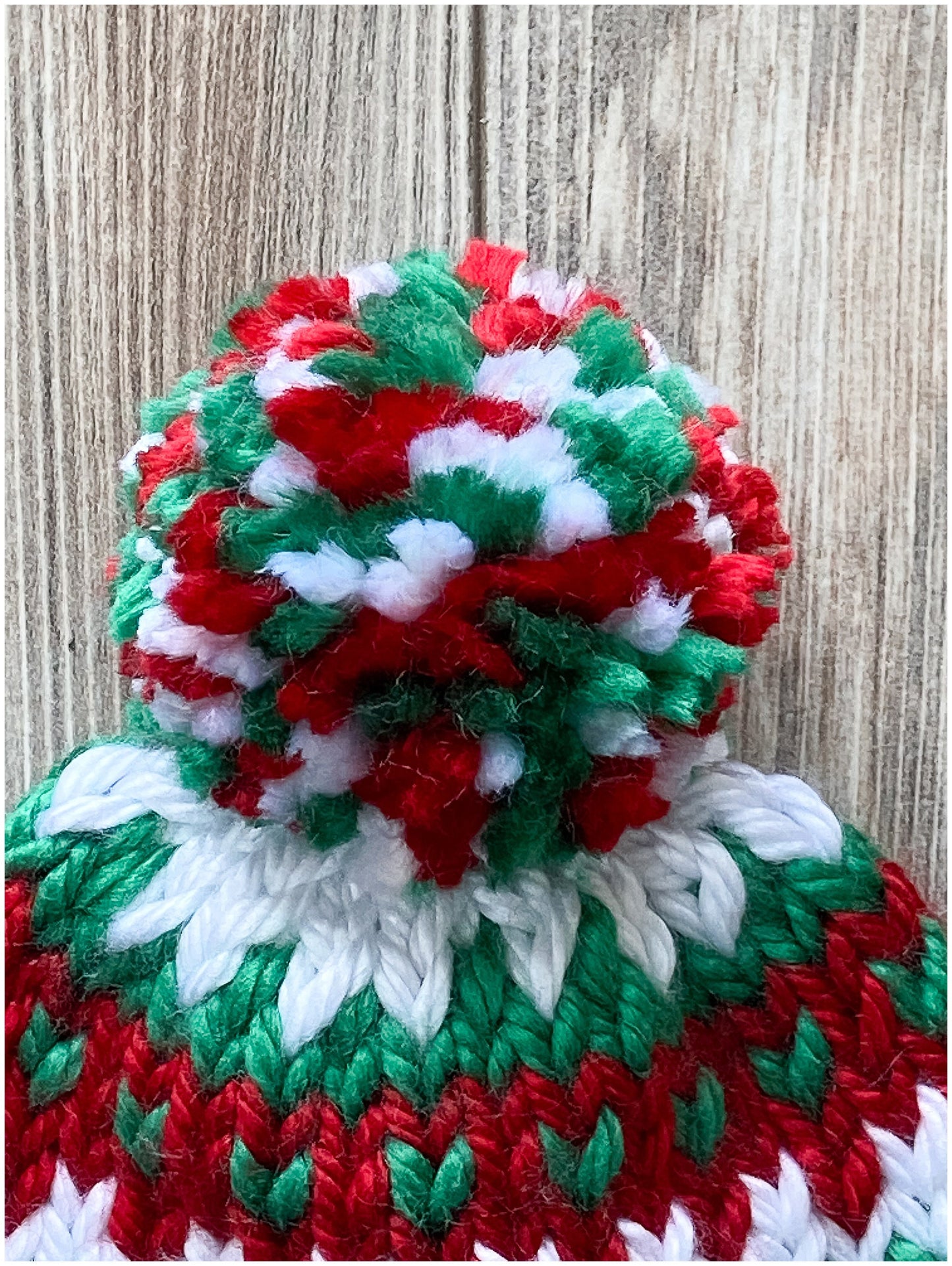 Toddler Christmas hat knit in a fair isle pattern of red and green with white accent color
