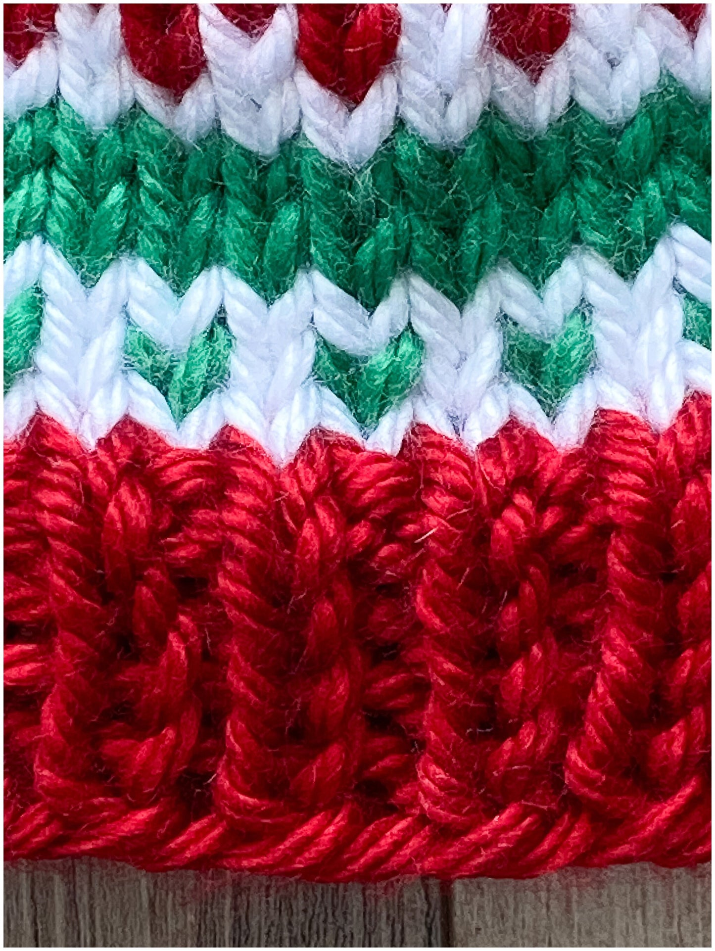 Toddler Christmas hat knit in a fair isle pattern of red and green with white accent color