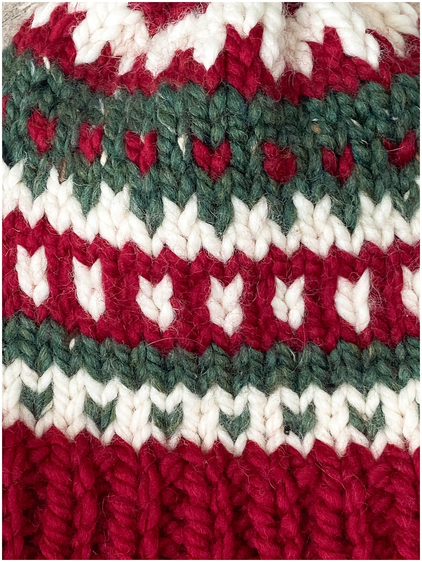 Women's Christmas hat knit in classic fair isle pattern with faux fur pom-pom
