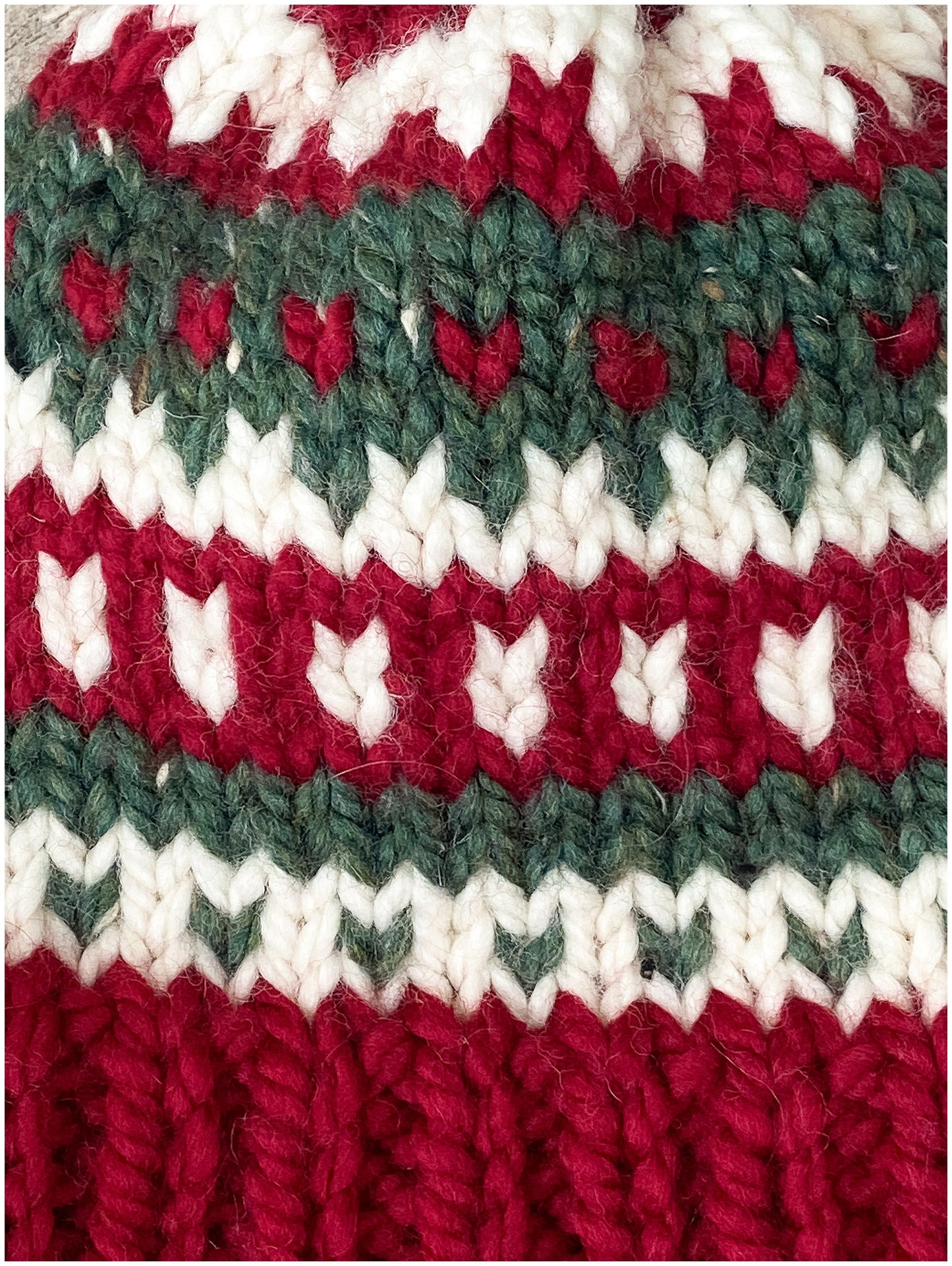Women's Christmas hat knit in classic fair isle pattern with faux fur pom-pom