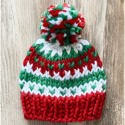 Toddler Christmas hat knit in a fair isle pattern of red and green with white accent color